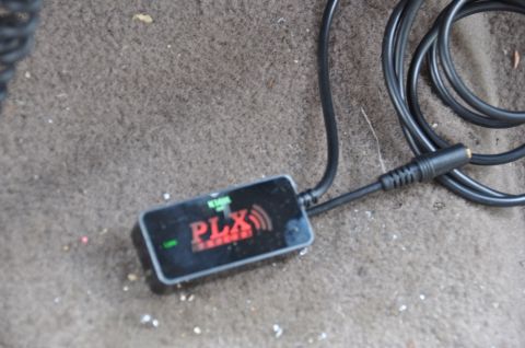 1996 Ford Bronco - PLX device on the floor of a vehicle, connected to a cable.
