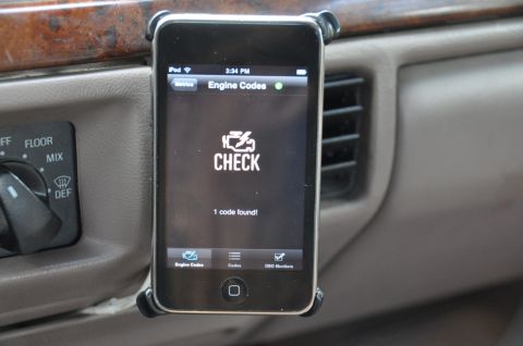 1996 Ford Bronco - An iPod Touch is used to check engine codes inside a vehicle's interior.
