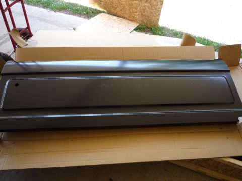 1990 Ford Bronco - A dark gray tailgate panel is shown laid flat on cardboard packaging.