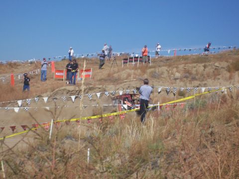 1993 Ford Bronco - A buggy navigates a challenging course as onlookers observe the event from the elevated terrain.