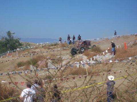1993 Ford Bronco - An off-road buggy navigates a challenging course with spectators observing the event.