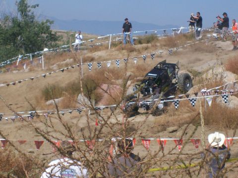 1993 Ford Bronco - Custom off-road buggy competes on a challenging course with spectators present.