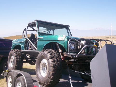 1993 Ford Bronco - This heavily modified off-road vehicle features a custom roll cage and oversized tires, suggesting it's built for extreme terrain.