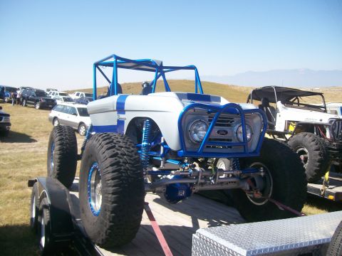 1993 Ford Bronco - Customized 1966 Ford Bronco rock crawler, modified for off-road use, parked on a trailer.