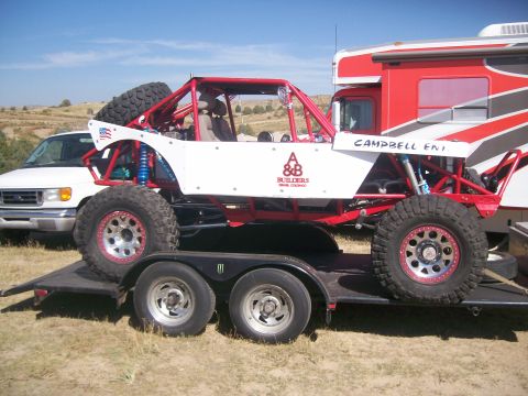 1993 Ford Bronco - Custom off-road buggy with "CAMPBELL ENT." and "A&B BUILDERS" logos is loaded on a trailer.