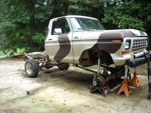 1979 Ford F-150 - This lifted Ford pickup truck is undergoing maintenance, with its front end elevated on jack stands.