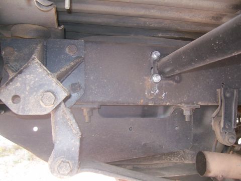 1993 Ford Bronco - Undercarriage view of a vehicle's frame and suspension components, showing signs of wear and tear.