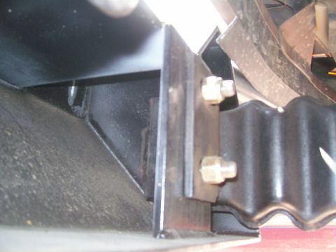 1993 Ford Bronco - Close-up view of a vehicle's bumper mounting hardware, showing a bracket and bolts.