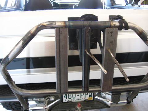 1995 Ford Bronco - Custom rear bumper fabrication in progress, showing welding and measurement marks. A Colorado license plate is visible.
