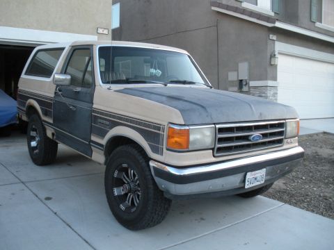 1990 Ford Bronco - This Ford Bronco has a two-tone paint job with a matte gray hood and custom wheels.
