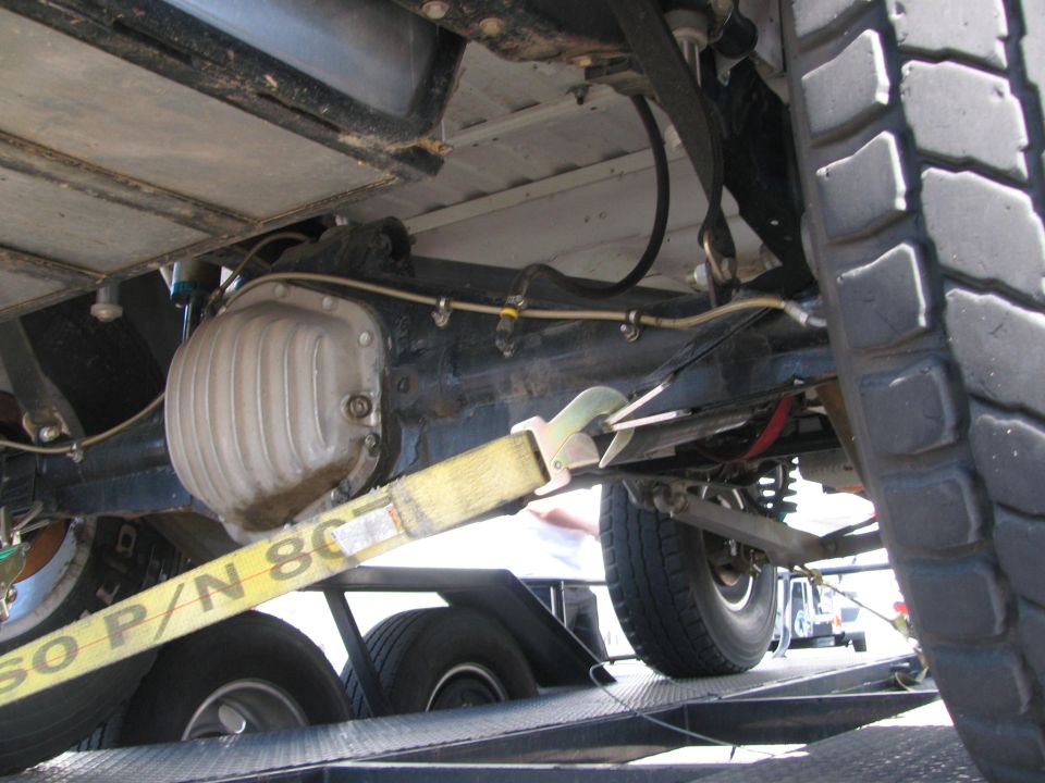 Underbody view of a vehicle on a trailer showing differential and rear axle