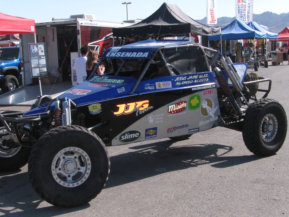 Blue tube-frame off-road race buggy with JJ's Ensenada graphics on large knobby tires