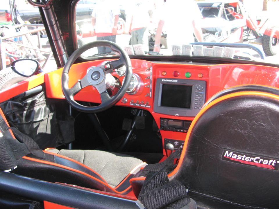 Off-road race vehicle interior with steering wheel and MasterCraft seat