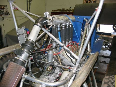 1993 Ford Taurus - Custom engine bay with exposed components and a roll cage structure.