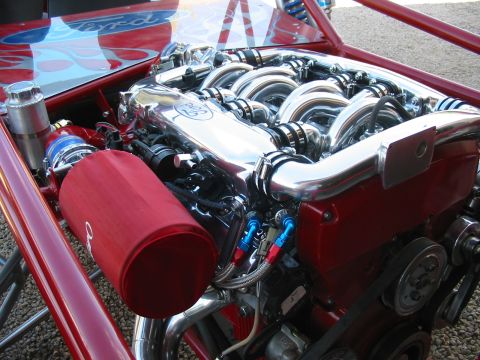 1993 Ford Taurus - Close-up of a custom engine build polished intake runners and a red air intake filter.