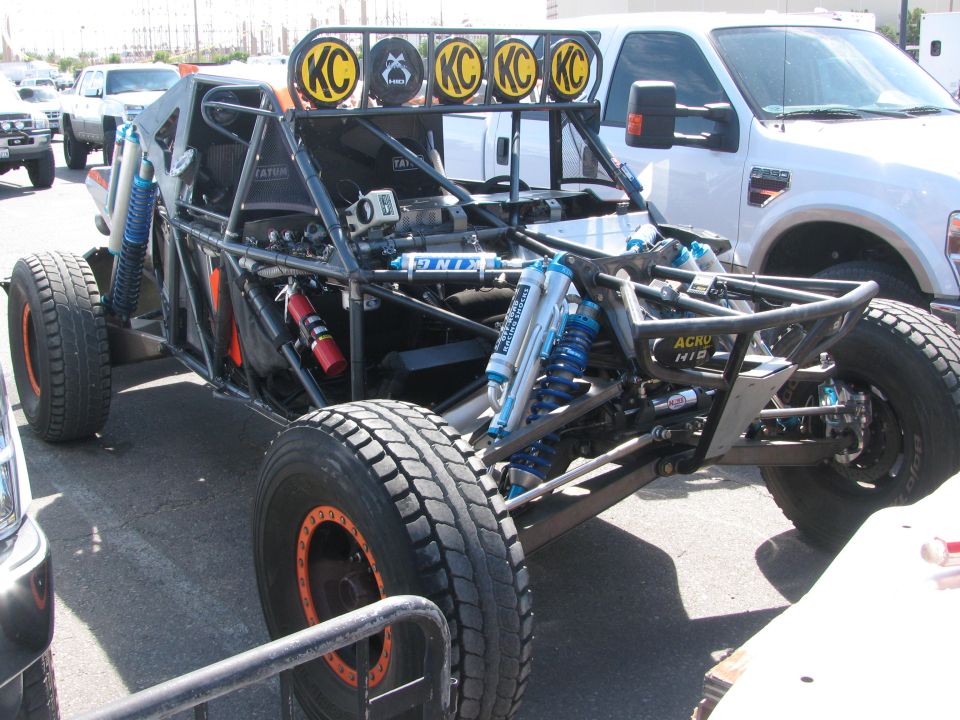 Tube-chassis off-road buggy with KC light bar, blue shocks and exposed frame