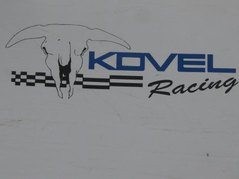 1990 Ford Bronco - Kovel Racing decal featuring a longhorn skull and checkered-flag stripes applied to a white body panel.