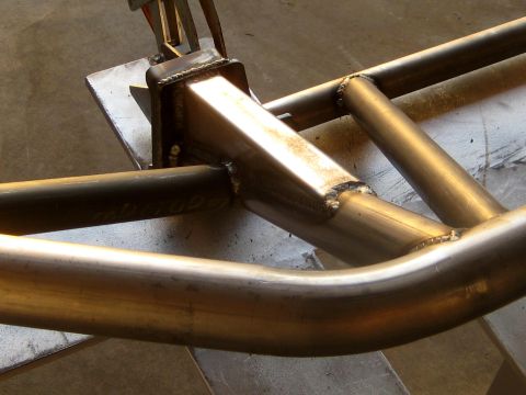 1996 Ford Bronco - Close-up view of a custom metal bumper being fabricated with visible welds and tubing.