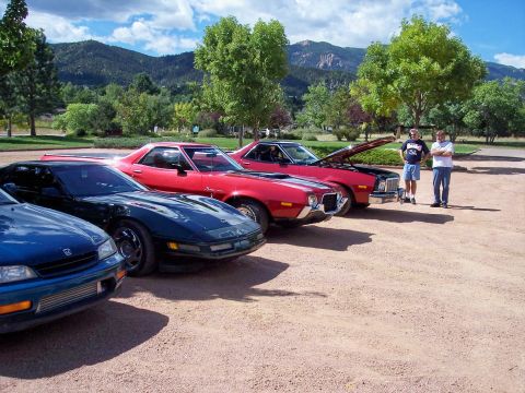 1972 Ford Ranchero - Three classic cars, including a 1972 Ford Ranchero, are parked in a line on a sunny day.