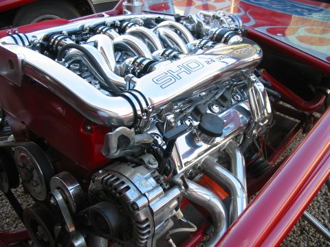 1993 Ford Taurus - Close-up of a highly polished SHO 24 valve DOHC engine, chrome components and red bodywork.