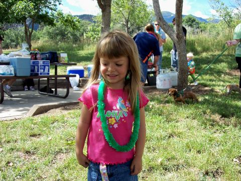 1972 Ford Ranchero - A young girl smiles while wearing a lei at an outdoor gathering.