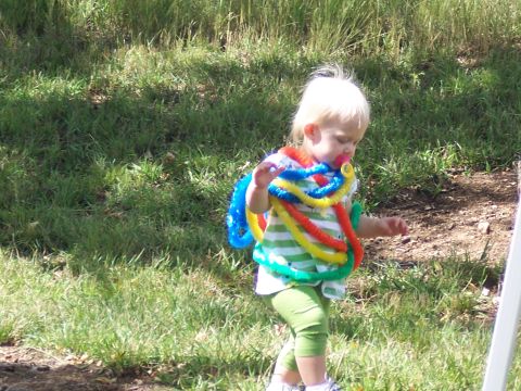 1972 Ford Ranchero - Toddler playing outdoors with a colorful toy necklace draped around their neck.
