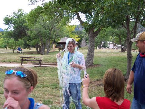 1972 Ford Ranchero - A group of people enjoy a picnic, with one individual playfully covered in streamers.