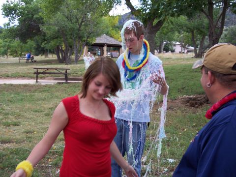 1972 Ford Ranchero - Two people are tangled in streamers at a park gathering.