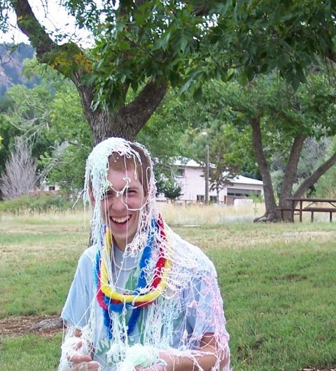 1972 Ford Ranchero - A person is covered in streamers and wearing a lei in an outdoor setting with trees and a building in the background.