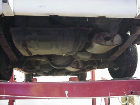 1977 Ford Mustang II - The underside of a vehicle is shown, with the fuel tank and exhaust system visible.