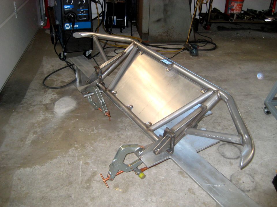 Custom metal fabrication project with clamps and welding equipment in background