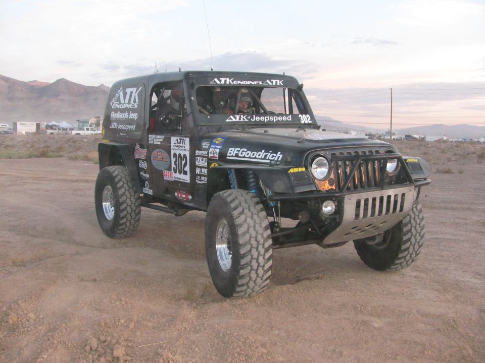 Black Jeep-style off-road race vehicle number 302 with ATK and BFGoodrich graphics