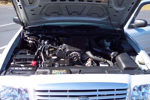 2001 Ford Crown Victoria - The engine bay of a 2001 Ford Crown Victoria is visible with the hood open.