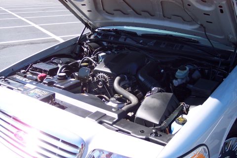 2001 Ford Crown Victoria - Engine bay of a 2001 Ford Crown Victoria, viewed from the front with the hood raised.