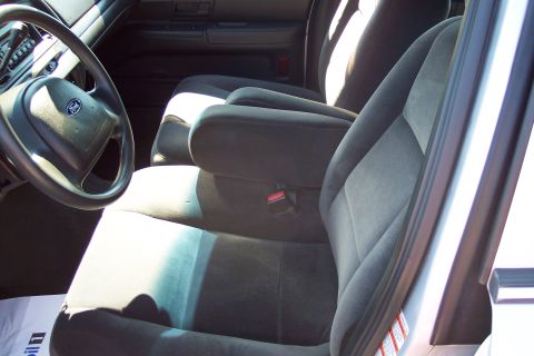2001 Ford Crown Victoria - The interior of a 2001 Ford Crown Victoria, with a focus on the front seats and dashboard details.