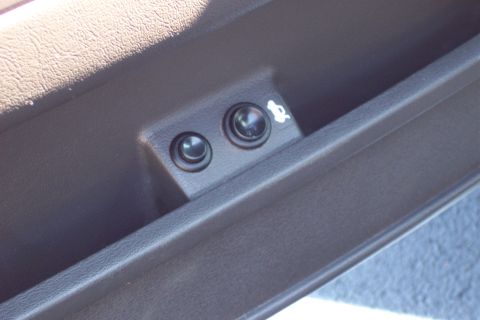 2001 Ford Crown Victoria - Interior door panel with two buttons and a trunk release icon.