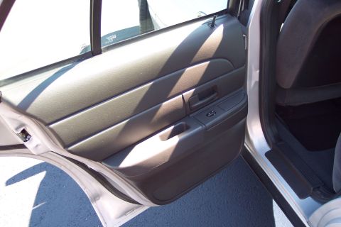 2001 Ford Crown Victoria - Interior door panel and seat of a car.