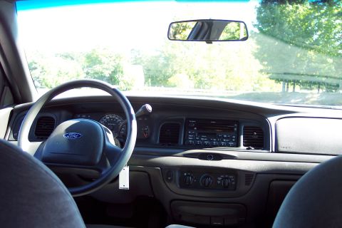 2001 Ford Crown Victoria - The interior of a Ford Crown Victoria is captured, highlighting the driver's side controls and dashboard.