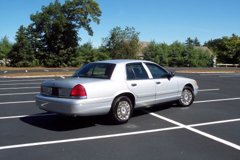 2001 Ford Crown Victoria - Silver 2001 Ford Crown Victoria sedan parked in a lot on a sunny day.