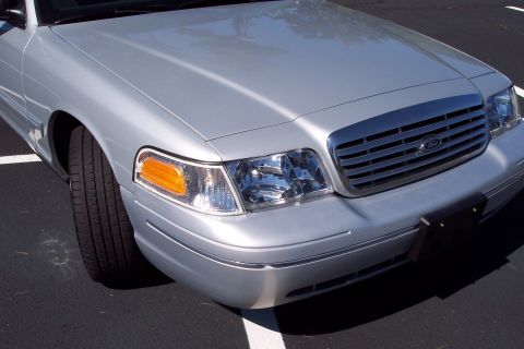 2001 Ford Crown Victoria - Front quarter view of a silver 2001 Ford Crown Victoria, parked on asphalt.