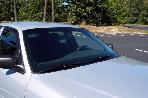 2001 Ford Crown Victoria - The front passenger side of a silver 2001 Ford Crown Victoria is shown parked outdoors.