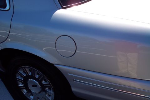 2001 Ford Crown Victoria - Close-up of the rear quarter panel on a 2001 Ford Crown Victoria, showing the fuel door and side trim.