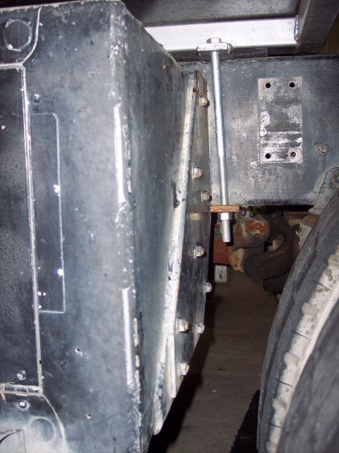 1981 Kenworth W900A - Detail shot of a truck's side frame, showing a large metal fuel tank and its mounting hardware.