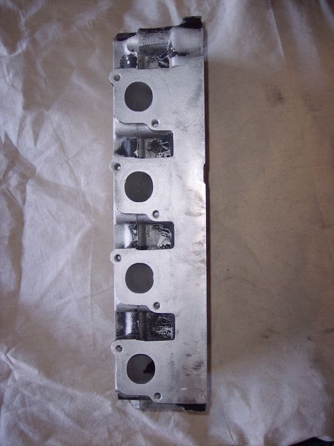 1971 Ford Mustang - Aluminum engine cylinder head with six intake ports, likely from a V6 or inline-6 engine.