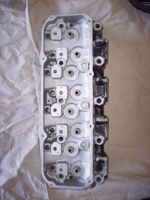 1971 Ford Mustang - Close-up of an engine cylinder head, showing internal components and casting marks. The part number E8ZM G049 C8 is visible.
