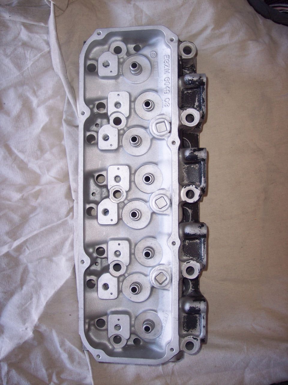 Engine cylinder head with casting numbers E8ZM G049 C8 visible