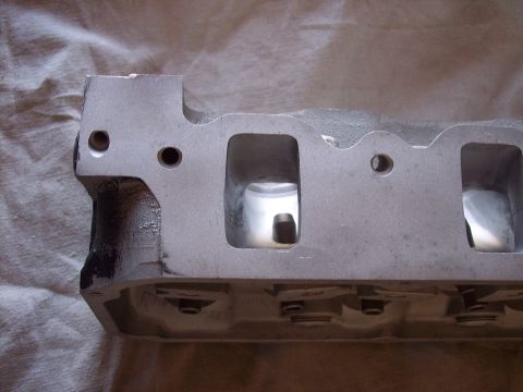 1971 Ford Mustang - Aluminum engine cylinder head shown from the side, revealing its internal structure and ports.