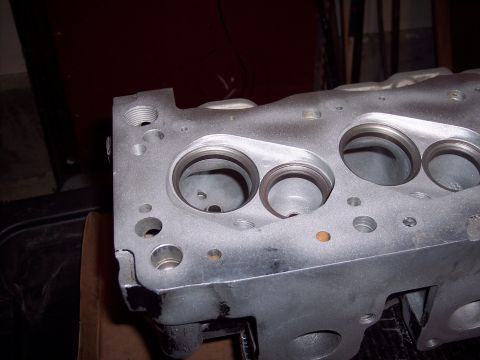 1971 Ford Mustang - Aluminum engine cylinder head with visible ports and bolt holes.