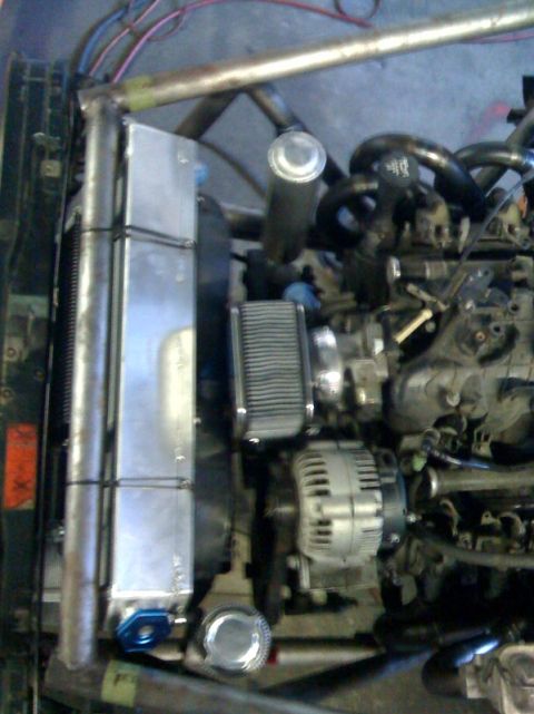 1994 Jeep YJ - Custom engine bay modifications visible, including an aftermarket radiator and air intake system.