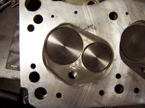 1971 Ford Mustang - A close-up view of an engine's cylinder head, showing two prominent valves.